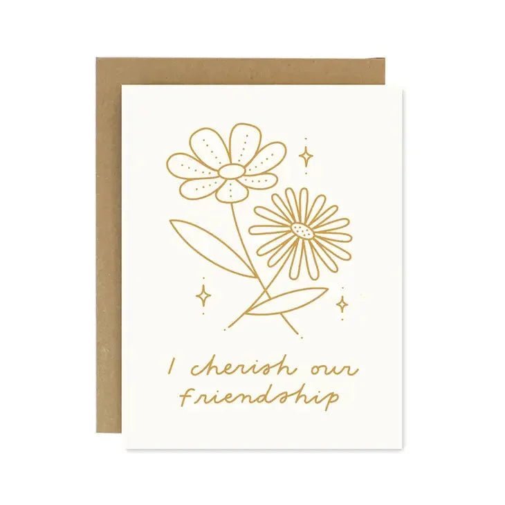 Worthwhile Paper’s "I Cherish Our Friendship Card" features two gold flowers and handwritten text on recycled paper, paired with a brown envelope—an elegant way to celebrate friendship.