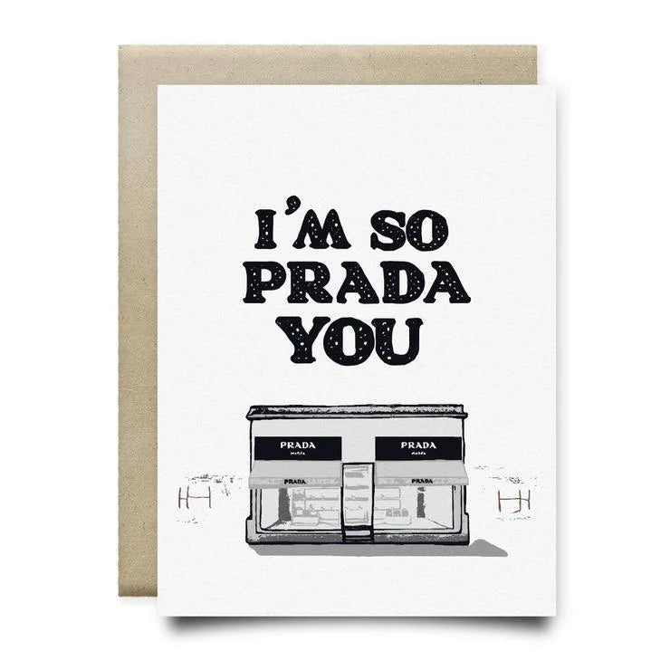 The “I’m So Prada You Card” by Anvil Cards features the phrase above a Prada storefront illustration, printed on luxe linen paper. A2 card, blank inside, with brown envelope.