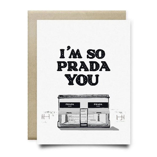 The "I'm So Prada You Card" by Anvil Cards is an A2 linen paper greeting card featuring “I’M SO PRADA YOU” and a Prada storefront illustration. Blank inside; includes a plain brown envelope.