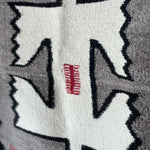 Close-up of a Klagetoh Rug Circa 1950 by Vintage, showcasing geometric white, black, and red patterns on gray—evoking classic Navajo weaving.