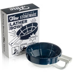 The Fine Accoutrements Lather Bowl, shown in blue and white with a handle, sits beside its packaging—ideal for whipping up traditional shaving soap with your favorite brush.