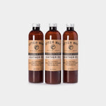 Three bottles of Otter Wax Leather Polishing Oil, each with brown liquid and beige labels, stand upright on a plain white background.