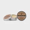 Two round metal tins of Otter Wax Leather Salve, one closed and one open to show the moisturizing formula inside, both labeled "Leather Salve | Otter Wax," placed on a plain white background.