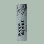 A cylindrical tube of Poppy & Pout Lip Balm featuring floral line art on the cap, displayed against a plain light green background.