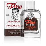 A 100ml bottle of L'Orange Noir Classic Aftershave by Fine Accoutrements, inspired by Terre d'Hermes, is shown beside its box with retro man artwork—ideal for those who appreciate classic aftershave fragrances.