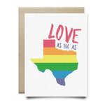 The Love as Big as Texas Card by Anvil Cards features a rainbow-striped Texas outline and bold “LOVE AS BIG AS” text on linen paper. This A2 greeting card is blank inside, ready for your personal note.
