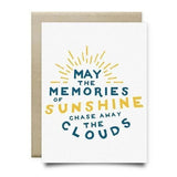 The Memories of Sunshine Sympathy Card by Anvil Cards is an A2 linen paper greeting card with "May the memories of sunshine chase away the clouds," sun rays, and blue and yellow accents; blank inside for your message.