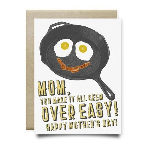 Anvil Cards’ “Mom Makes It Over Easy” is an A2 linen greeting card featuring a happy frying pan illustration and the text: "Mom, you make it all seem over easy! Happy Mother's Day!" Card is blank inside for your message.