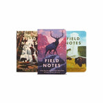 The Field Notes National Parks Pack includes three notebooks with illustrated covers of a waterfall, a deer with mountains, and bison in a field, all standing upright against a white background.