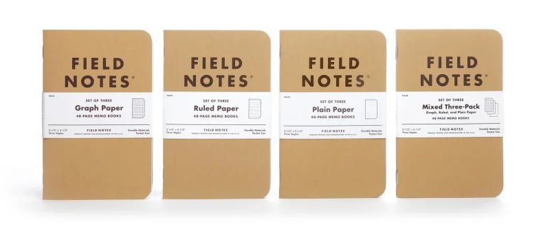 Four Field Notes Original Kraft packs are side by side—Graph Paper, Ruled Paper, Plain Paper, and Mixed Three-Pack. Each Field Notes pack contains three 48-page memo books.