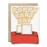 The "Poppy Tart Day Father's Day Card" by Anvil Cards features two toaster pastries popping from a red toaster with “Poppy Tart Day” above. Printed on linen paper, the A2 card is blank inside and comes with a brown envelope.