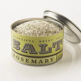 A partially open tin labeled "Rosemary Sea Salt | Beautiful Briny Sea" by Beautiful Briny Sea reveals coarse rosemary sea salt, an herbal seasoning.