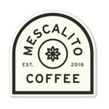 Mescalito Coffee’s Shop Stickers feature their black and white logo with a central stylized flower—ideal for small town coffee shop merchandise or unique coffee shop designs. Established in 2018.