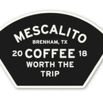 A black, fan-shaped Mescalito Coffee sticker reads "Mescalito Brenham, TX 2018 Coffee Worth the Trip" in bold white letters—perfect for fans of unique coffee shop apparel and new designs.