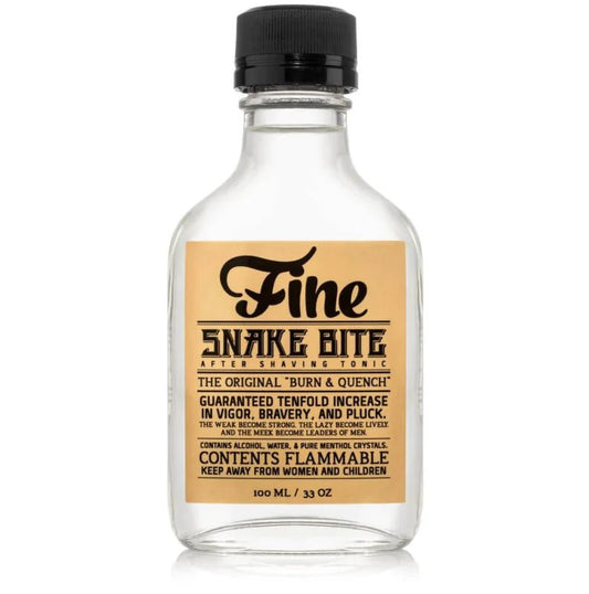 A clear rustic bottle labeled "Snake Bite Tonic | Fine Accoutrements" features a black cap, flammability warning, and highlights its powerful, invigorating menthol aftershave effects.
