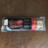 A packaged Yak Stick | Rogue Pet Feed dog chew lies on a brown leather surface. The label emphasizes its high protein content and quality ingredients, establishing it as a premium dog treat from Rogue Pet Feed.