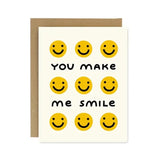The Worthwhile Paper "You Make me Smile Card" features nine yellow smiley faces and "YOU MAKE ME SMILE" text on a white background with a brown envelope—a cheerful blank greeting card for any occasion.